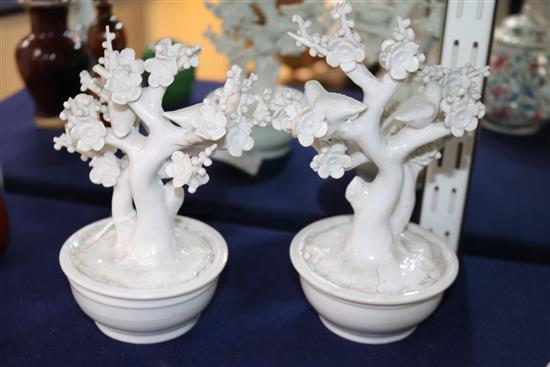 A pair of Chinese blanc de Chine models of birds in prunus trees